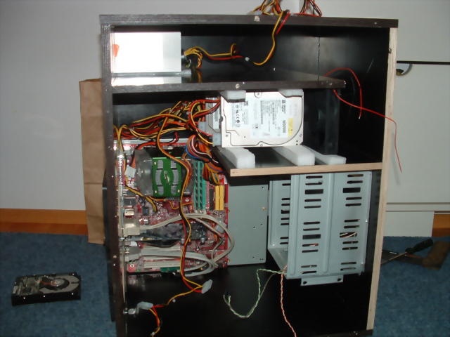 The plywood case with the computer components installed